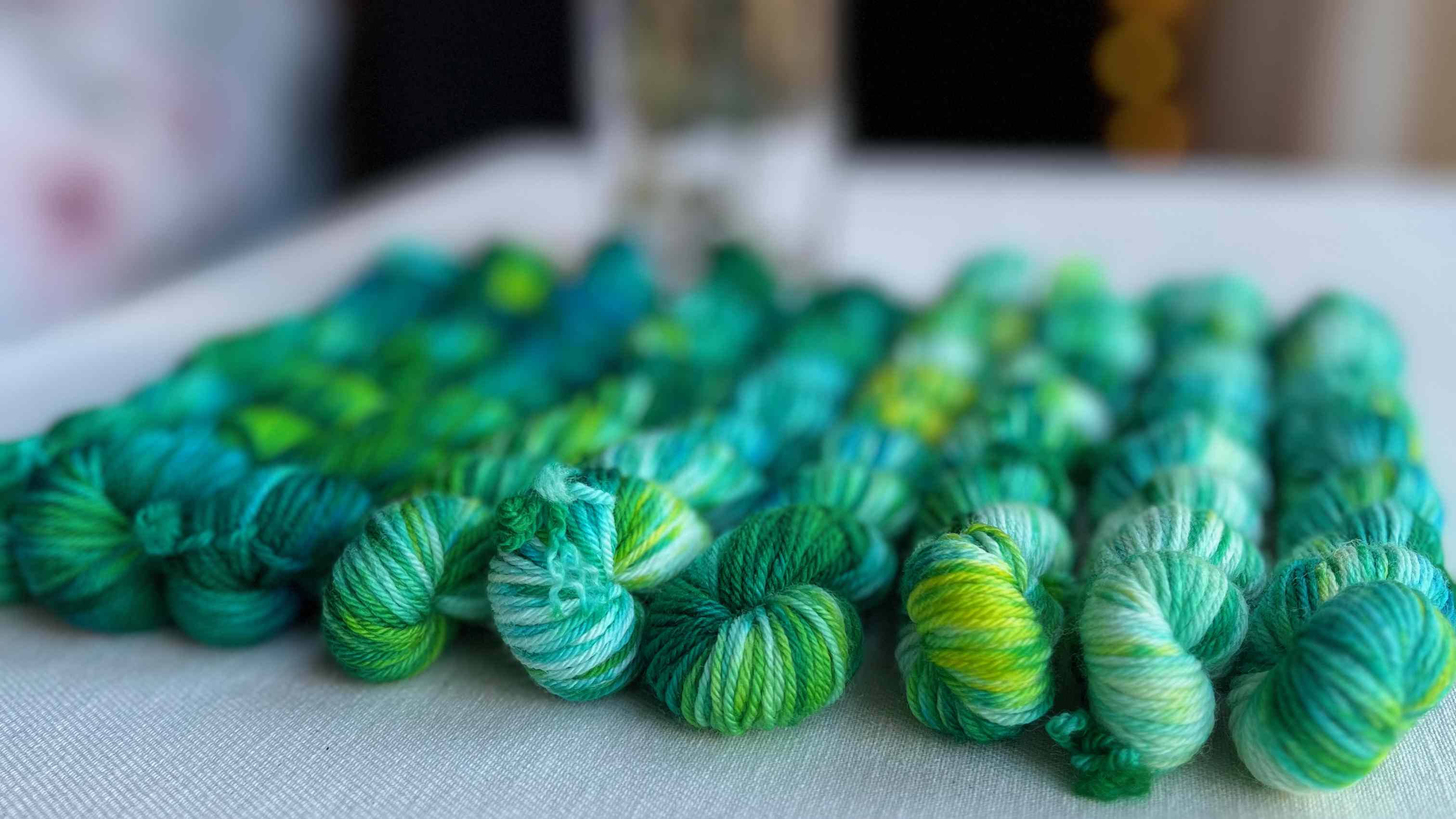 Colorful skeins of yarn on a tabletop.