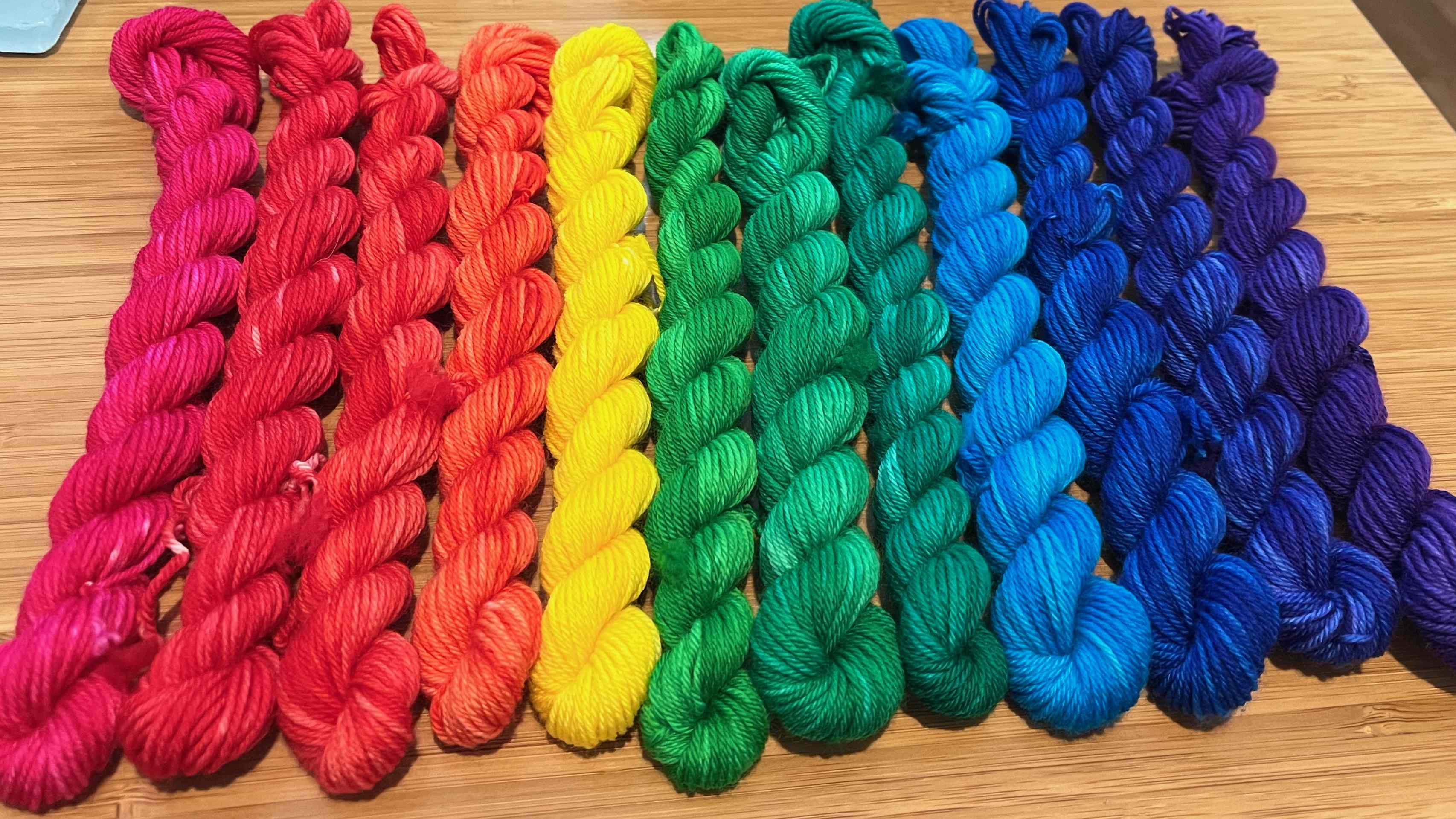 Colorful skeins of yarn on a tabletop.